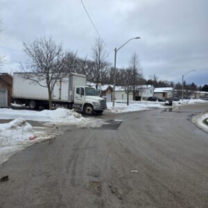 Movers unloading household items at a Brentwood home in Calgary.