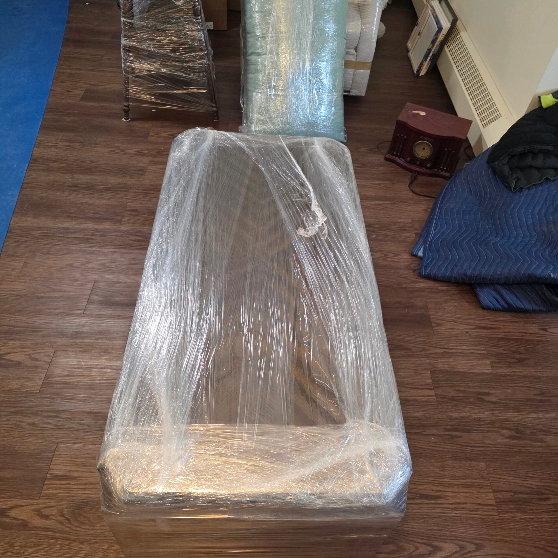 Larger furniture wrapped and secured for transit during a residential move in Surrey.
