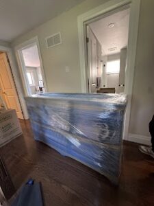 Wrapped media cabinet prepared for an apartment move in Montreal.