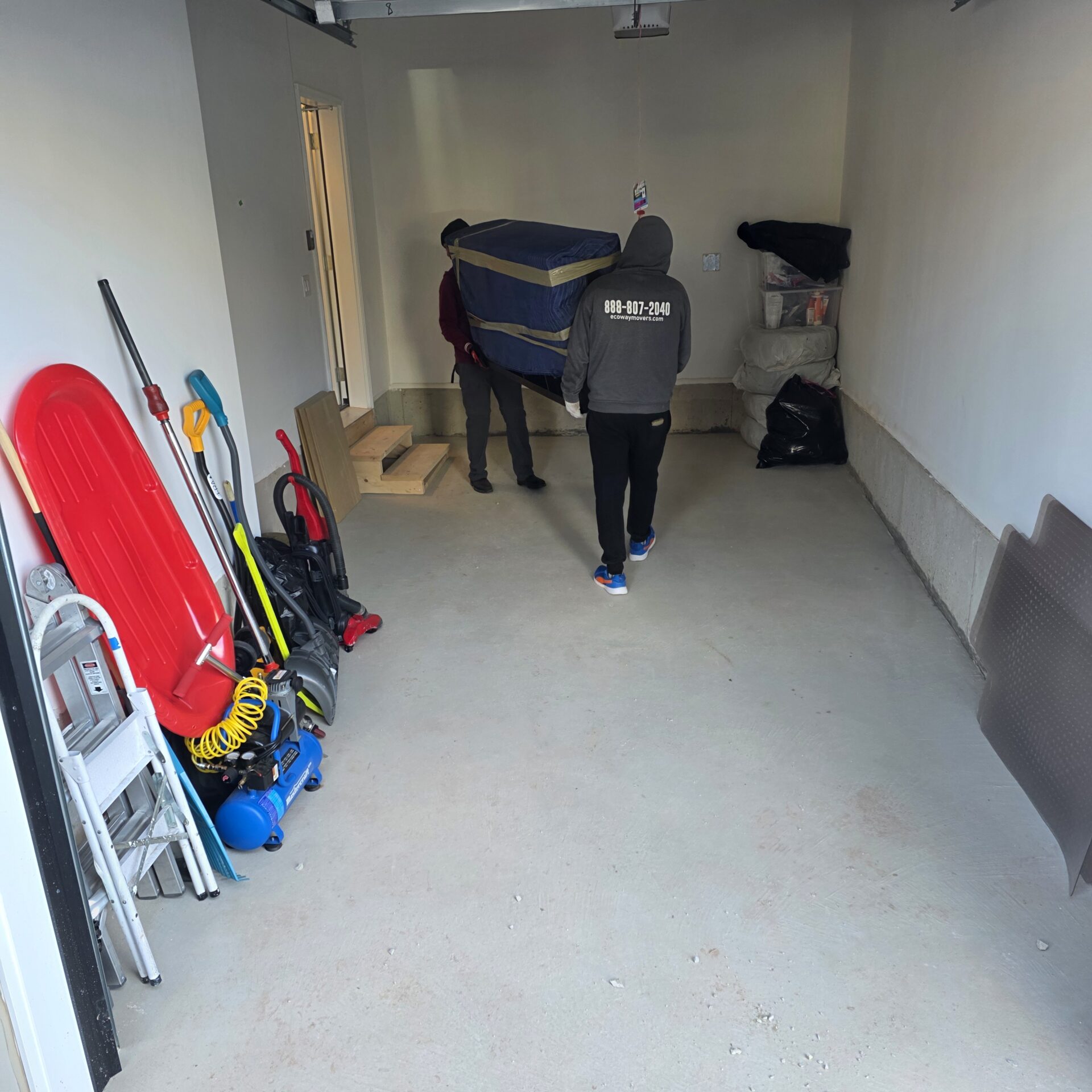 Boxes and furniture loaded carefully for transport into short-term storage.