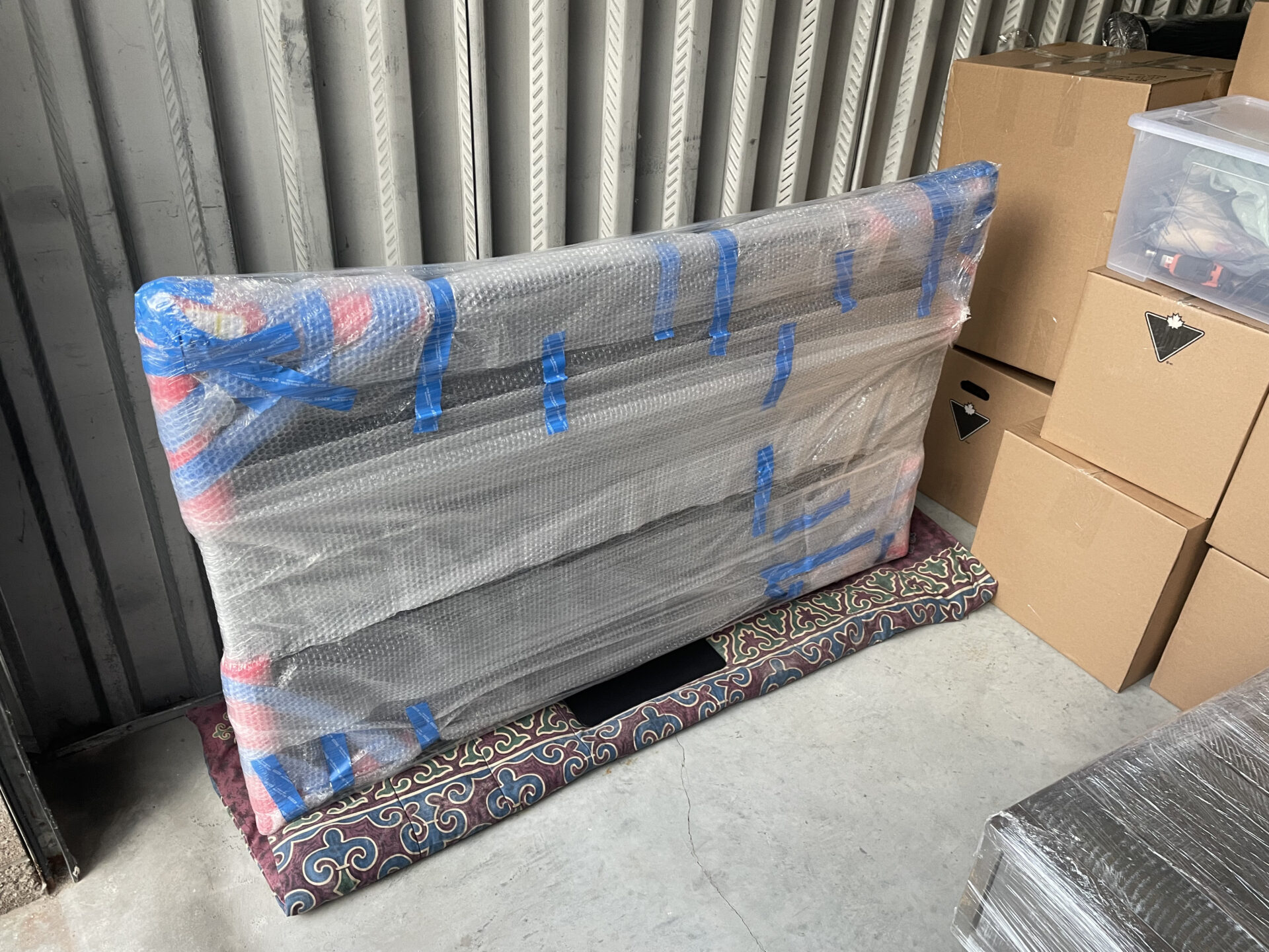 Thin glass dessert cups individually wrapped and secured upright in divider crates.