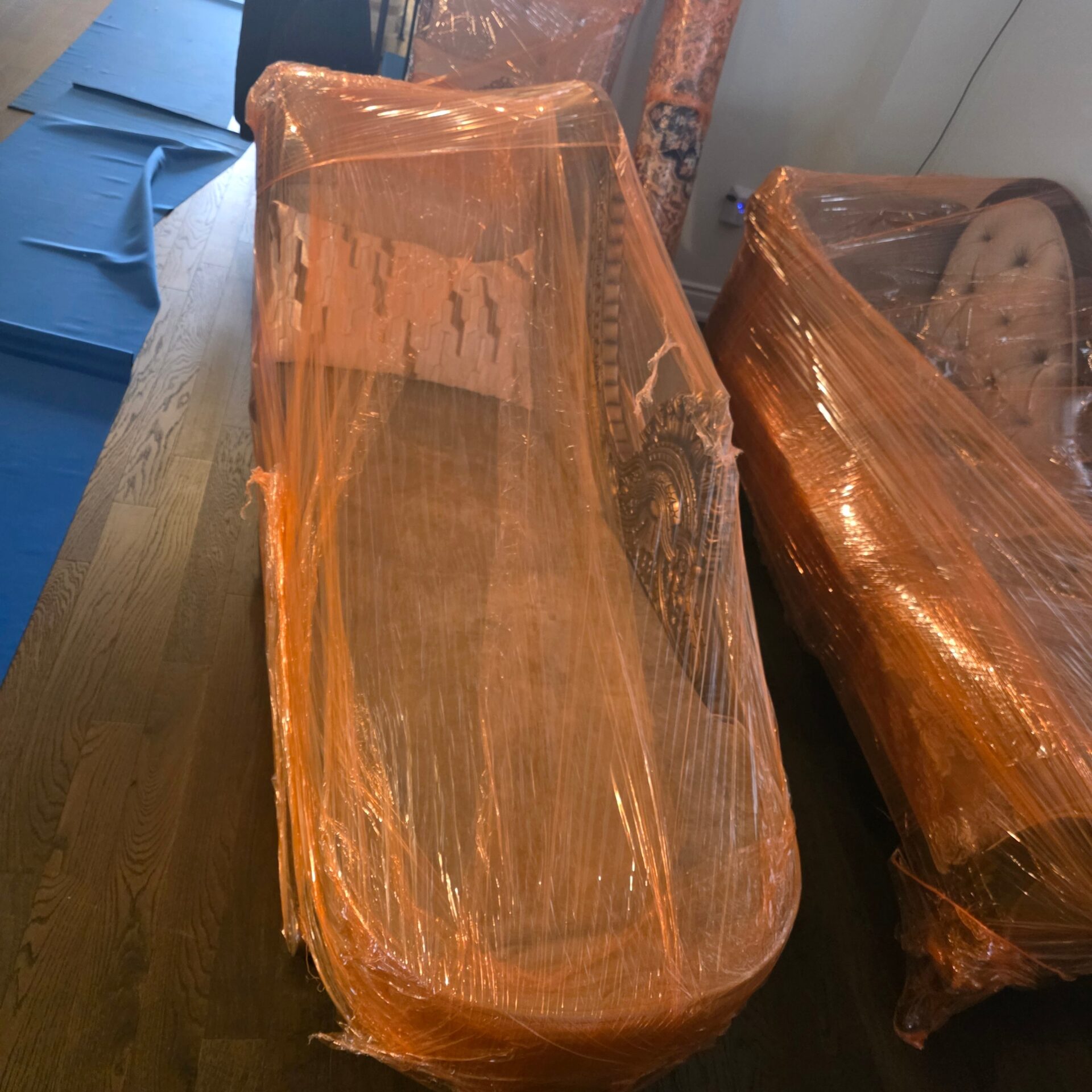 Fragile household décor items wrapped in bubble wrap and moving pads.