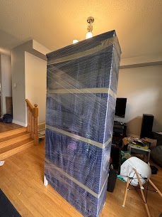 Movers carefully preparing furniture for a home move from Avalon to Queenswood Village in Orleans, ensuring safe winter transit.