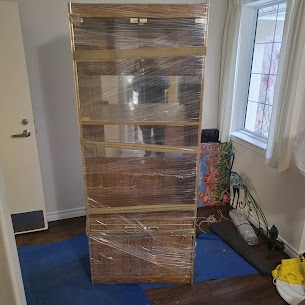 Movers carefully preparing furniture for a home move from Guildford to Green Timbers in Surrey, ensuring safe winter transit.