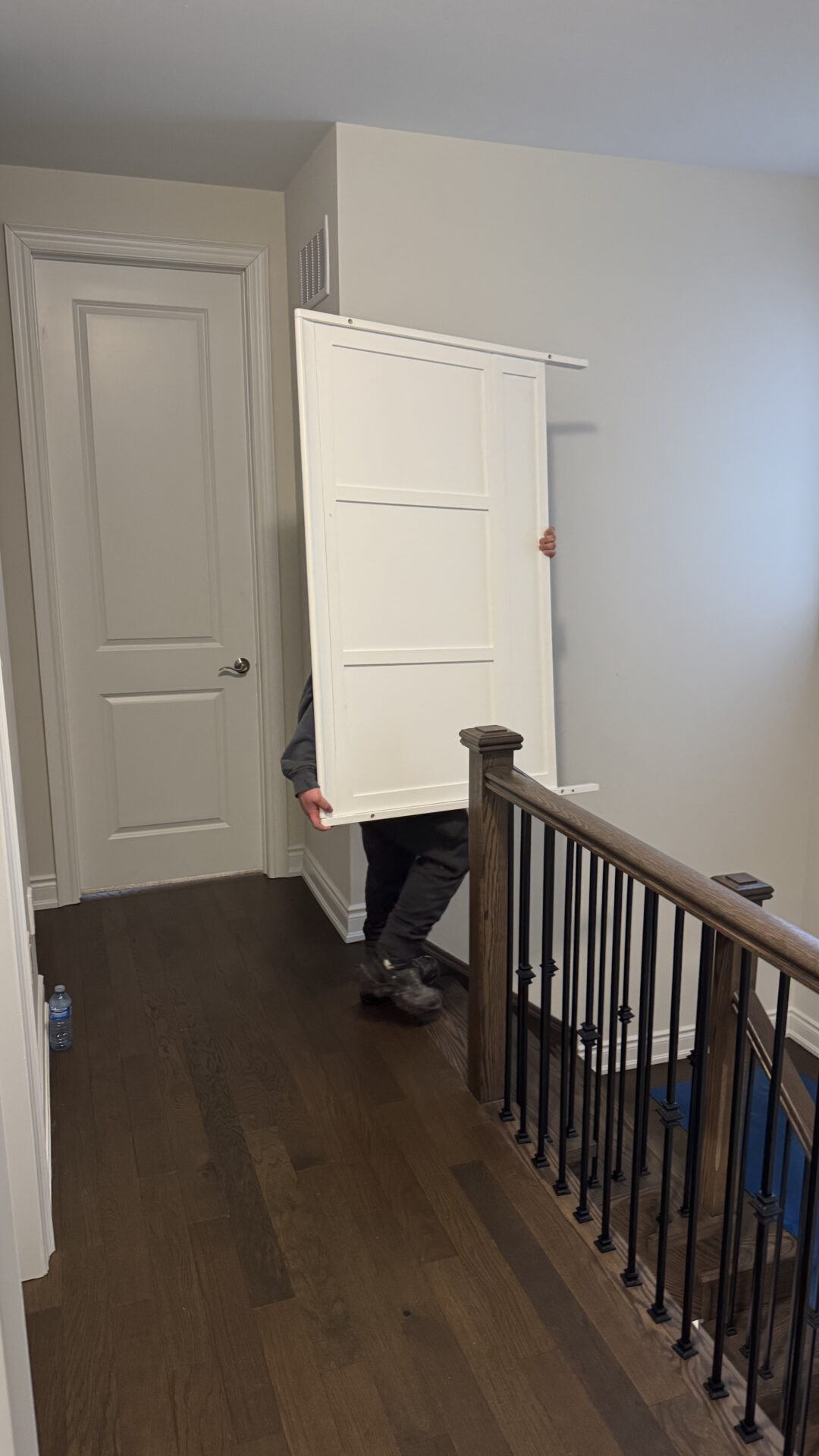 Professional movers maintaining clear pathways during the loading process in a Mimico home.
