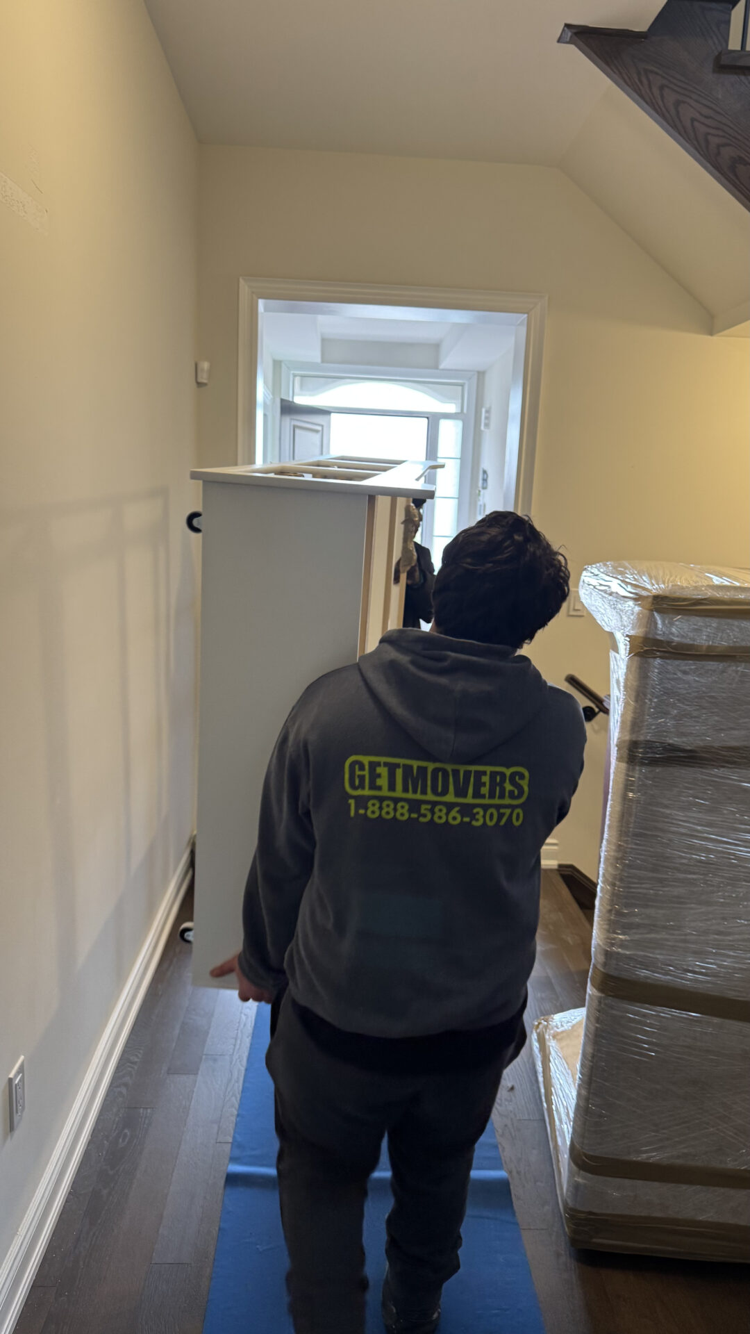 Protected floor runners and packed crates in an Ajax home.