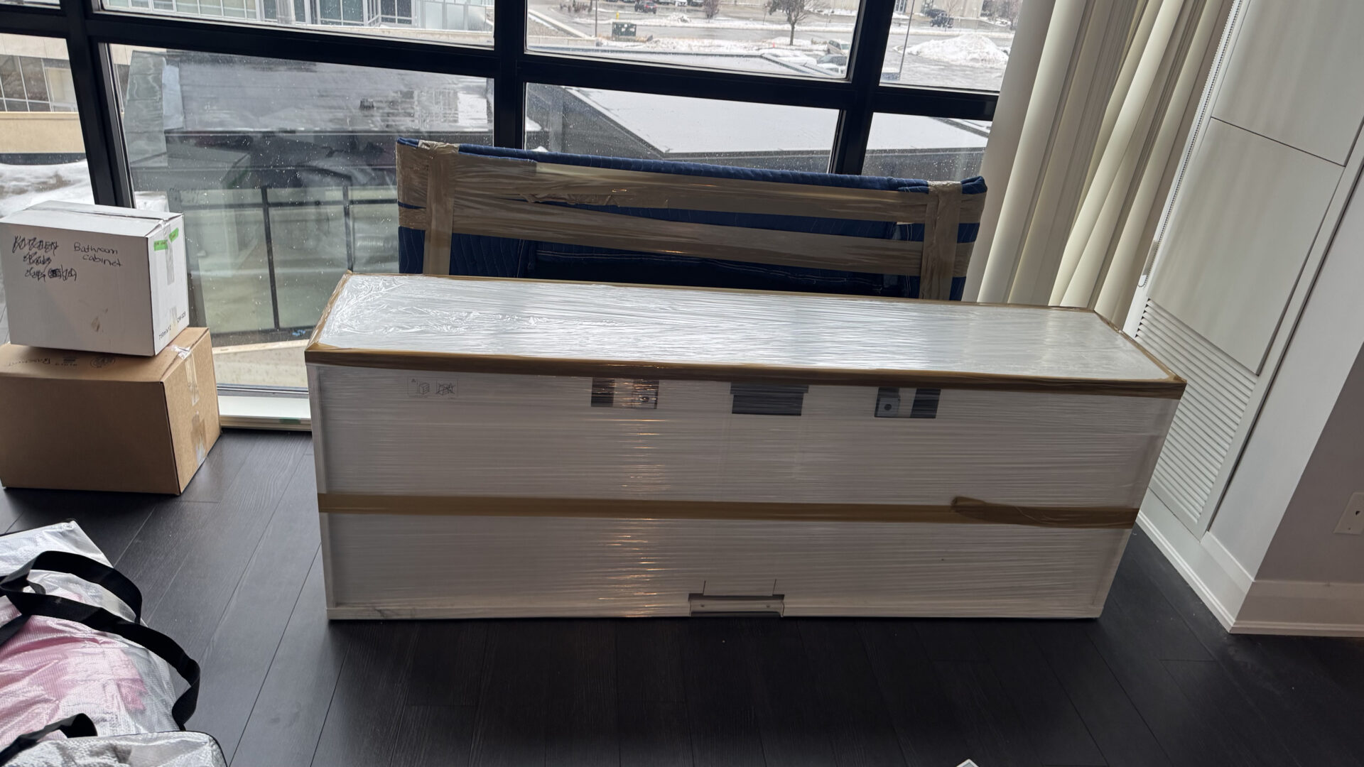 Professional movers maintaining clear pathways during the loading process in a Williamsburg home.