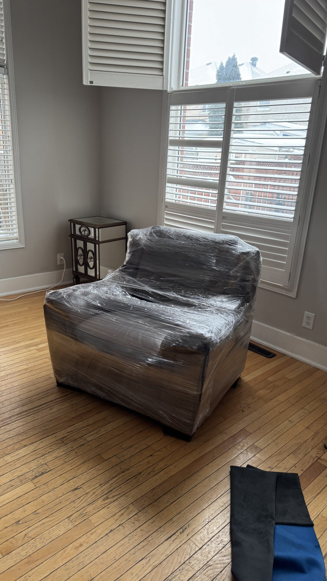 Professional movers maintaining clear pathways during the loading process in a Whitby Shores home.