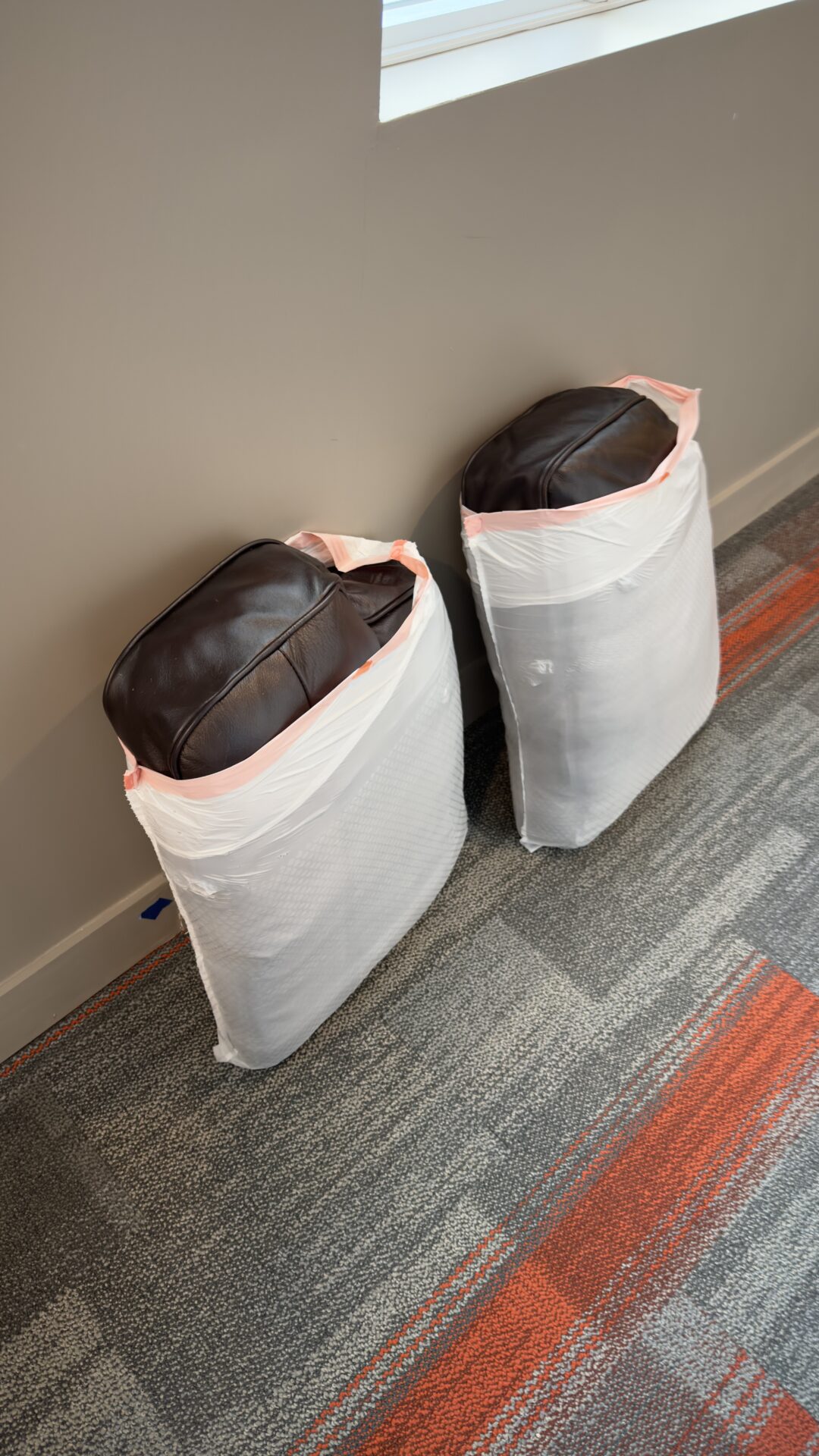 Professional movers maintaining clear pathways during the loading process in a Downtown condo.