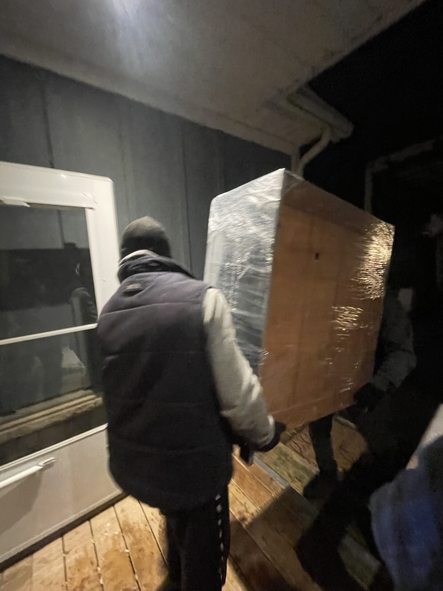 Movers ensuring clear, protected pathways during winter loading.