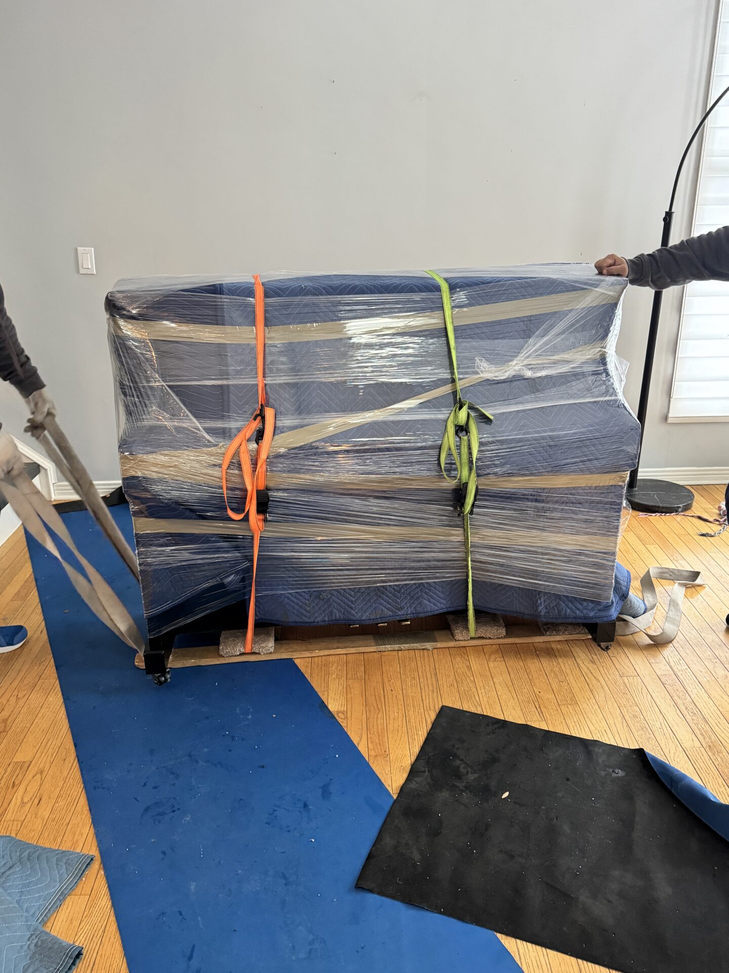 Professional movers maintaining clear pathways during the loading process in a West Alexander home.