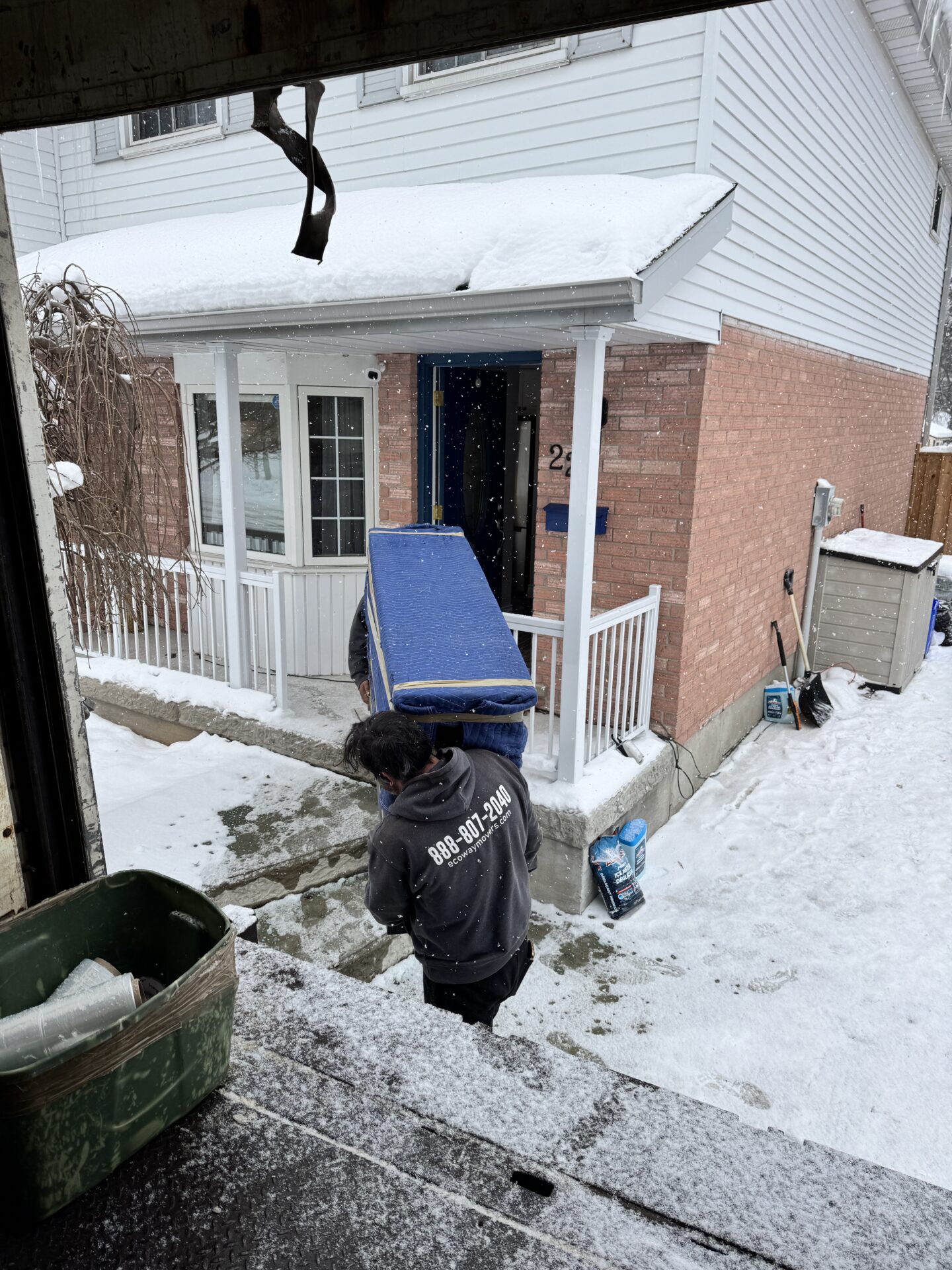 Professional movers maintaining clear pathways during the loading process in Winnipeg.
