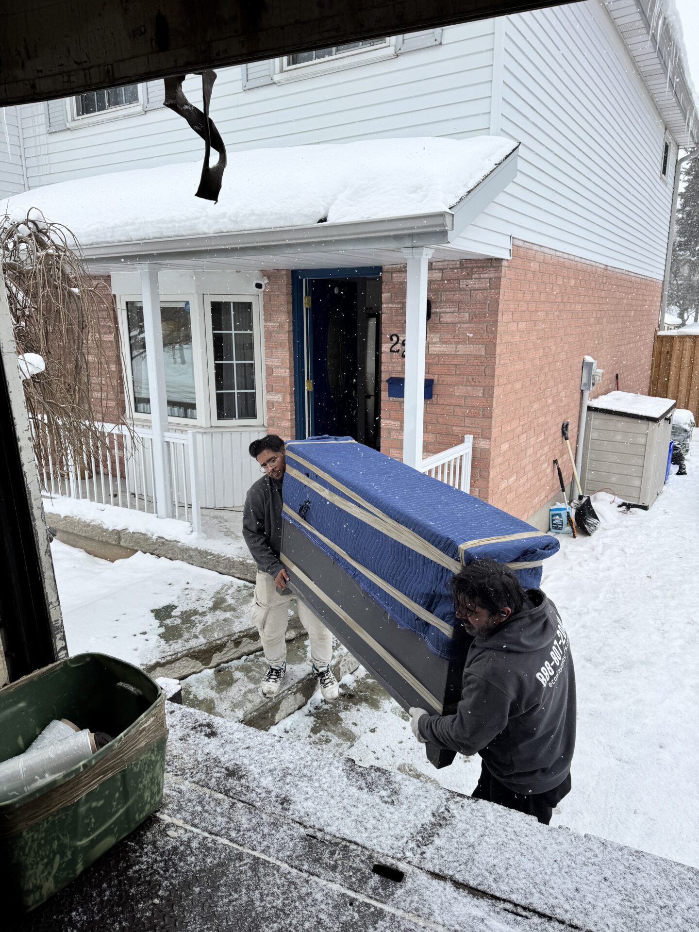 Professional movers maintaining clear pathways during the loading process in a Glenwood home.