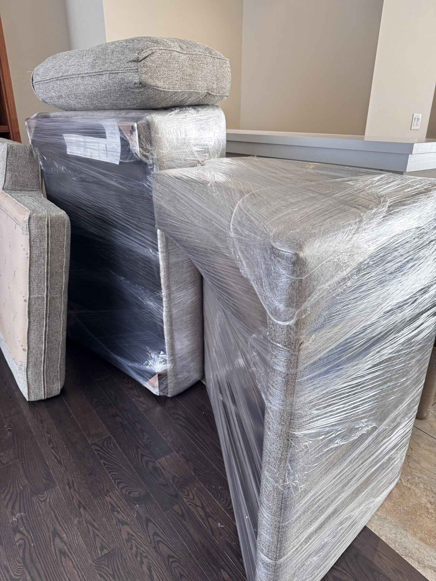 Wooden hutch wrapped in heavy-duty pads for protection during the move.