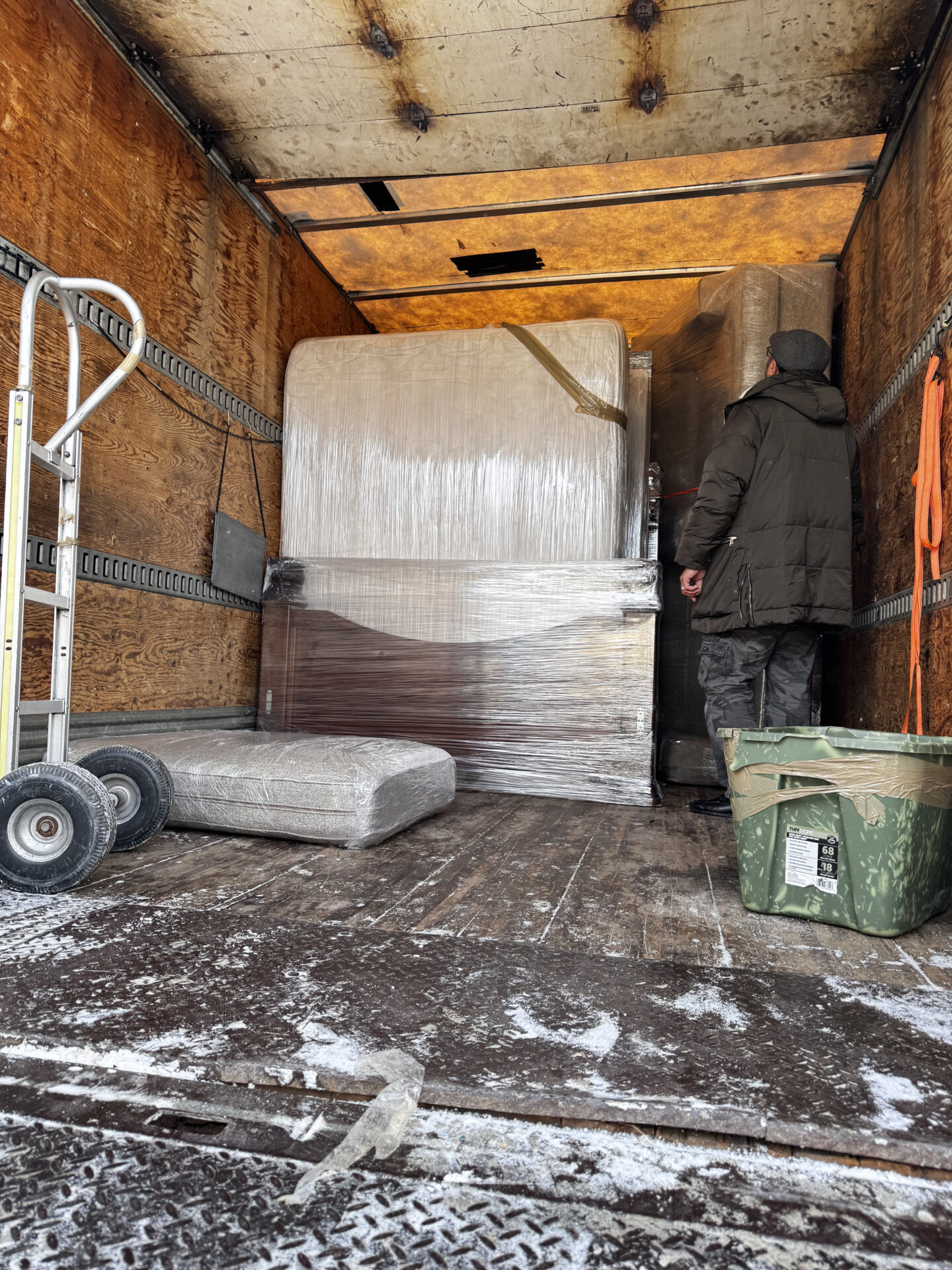Professional movers navigating snowy winter pathways in Edmonton.