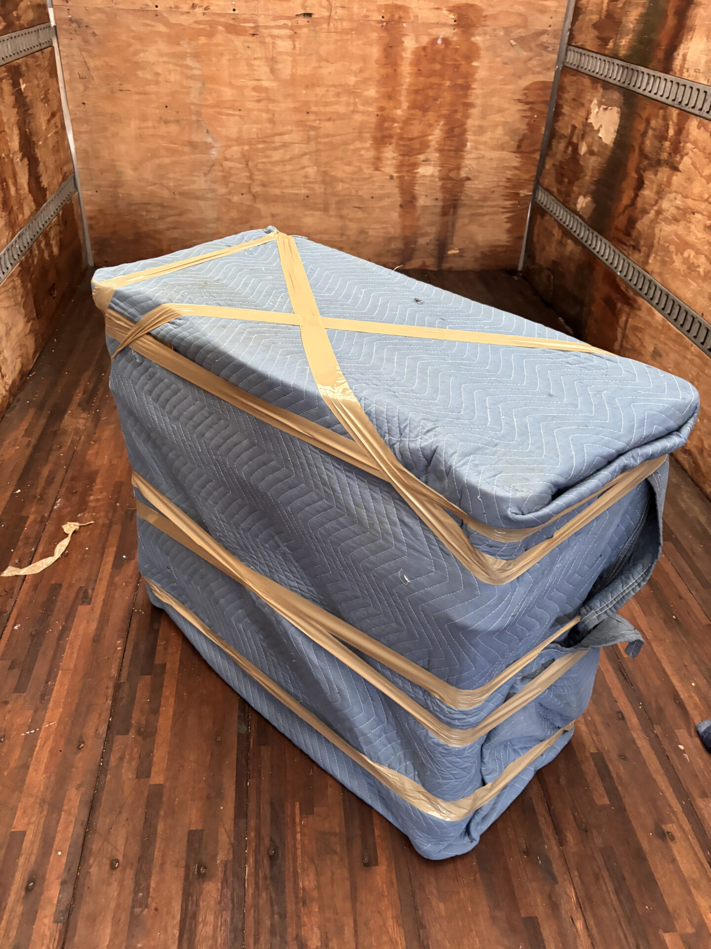 Movers organizing boxes and furniture in the moving truck.