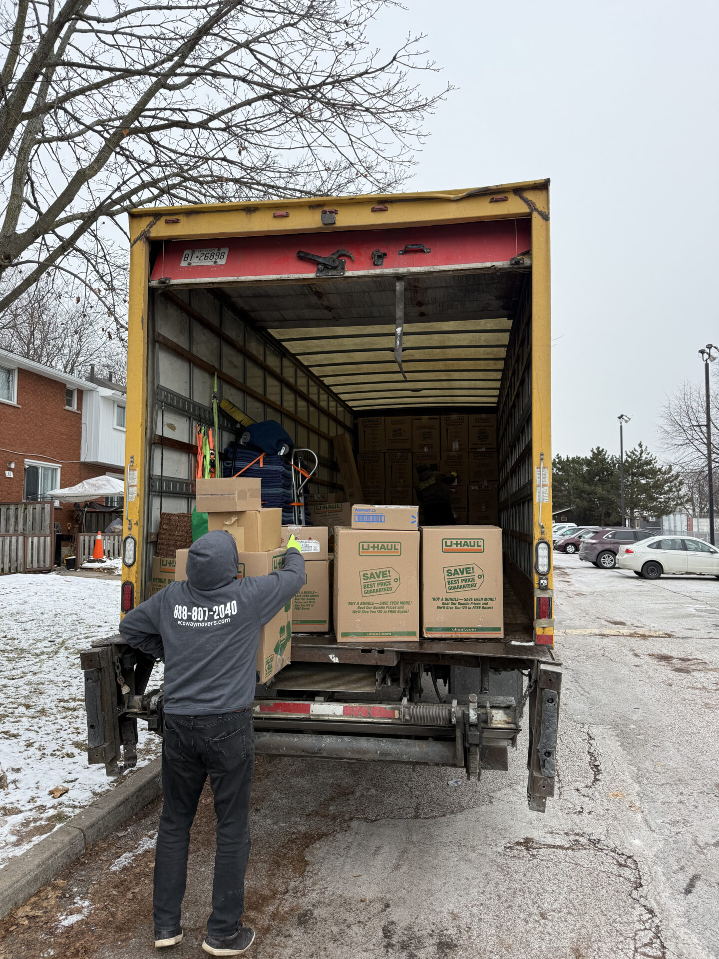 Professional movers maintaining clear pathways during the loading process in a Brampton home.