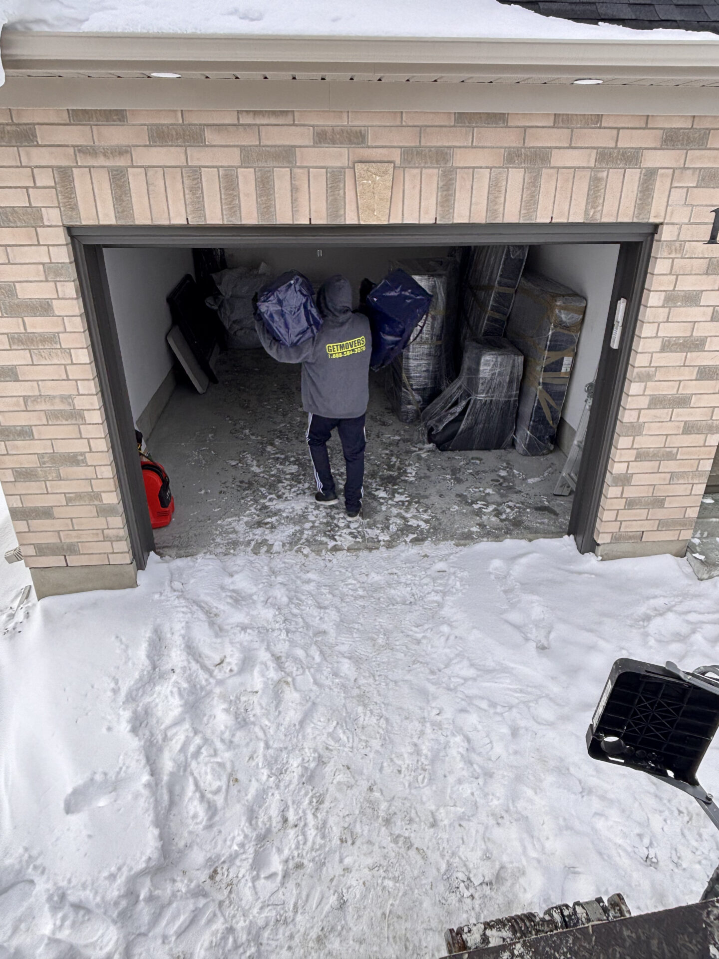 Professional movers maintaining clear pathways during the loading process in a Pringle Creek home.
