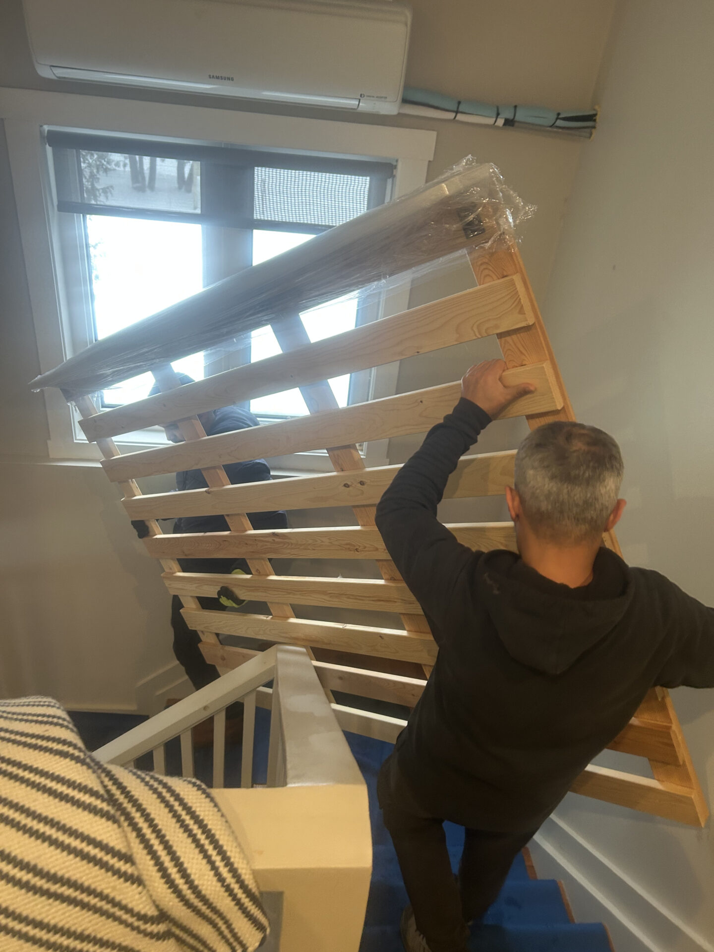 Professional movers maintaining clear pathways during the loading process in a Hazeldean home.