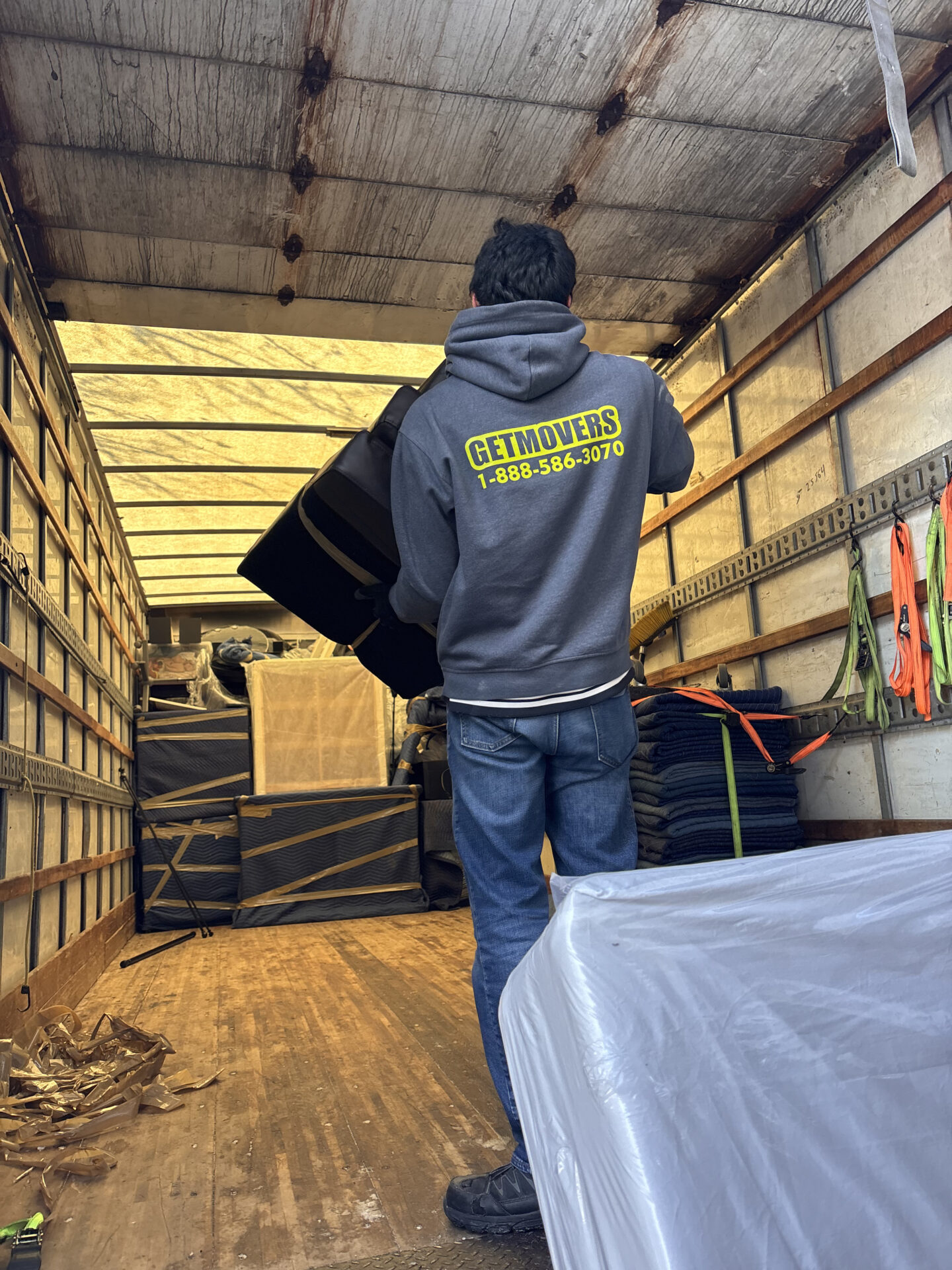 Professional movers maintaining clear pathways during the loading process in a Downtown Core home.