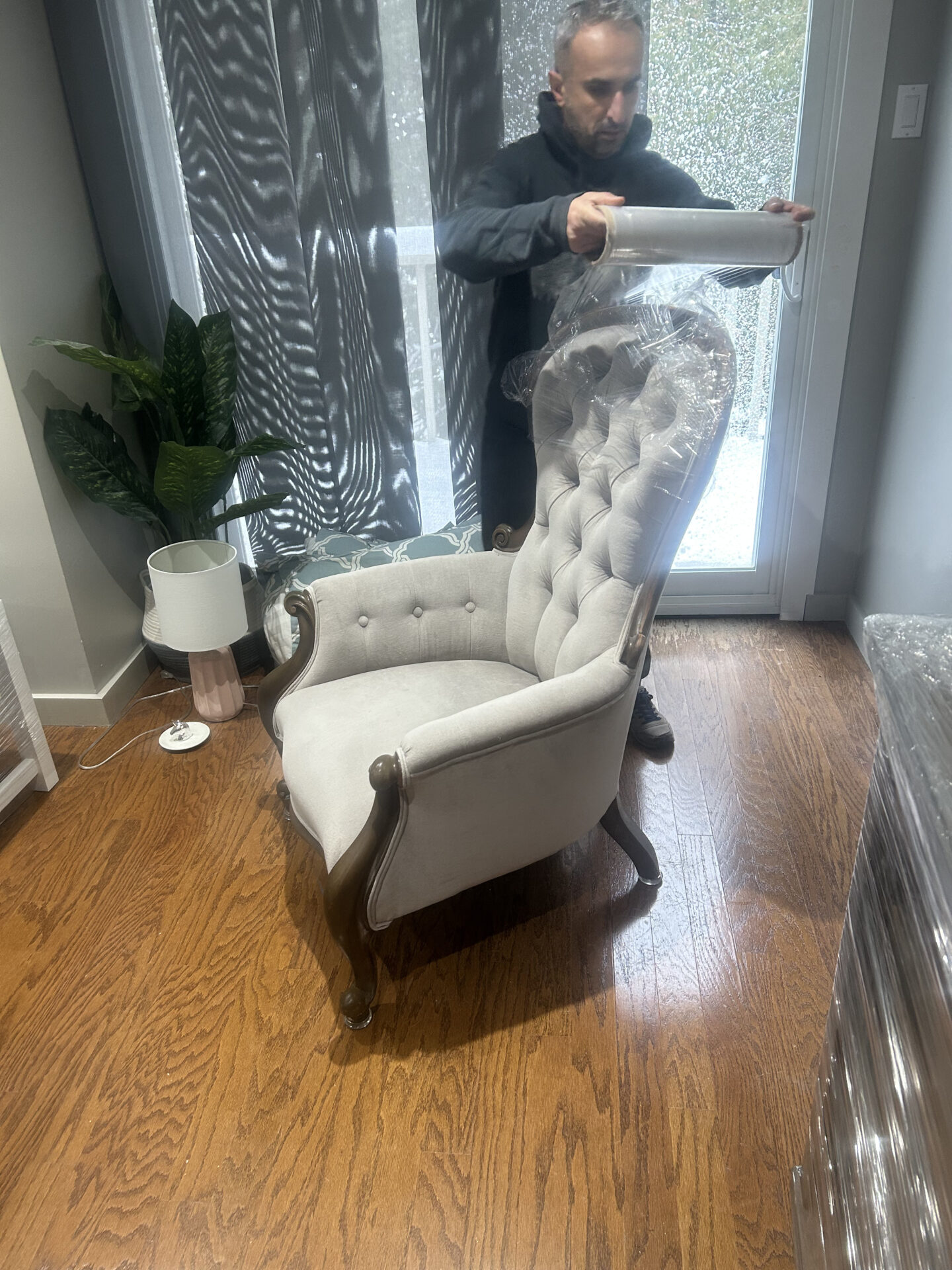 Professional movers maintaining clear pathways during the loading process in a Alberta Avenue home.