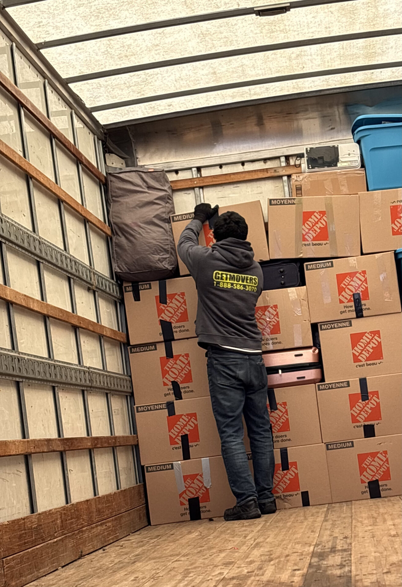 Professional movers maintaining clear pathways during the loading process in a Glenora home.