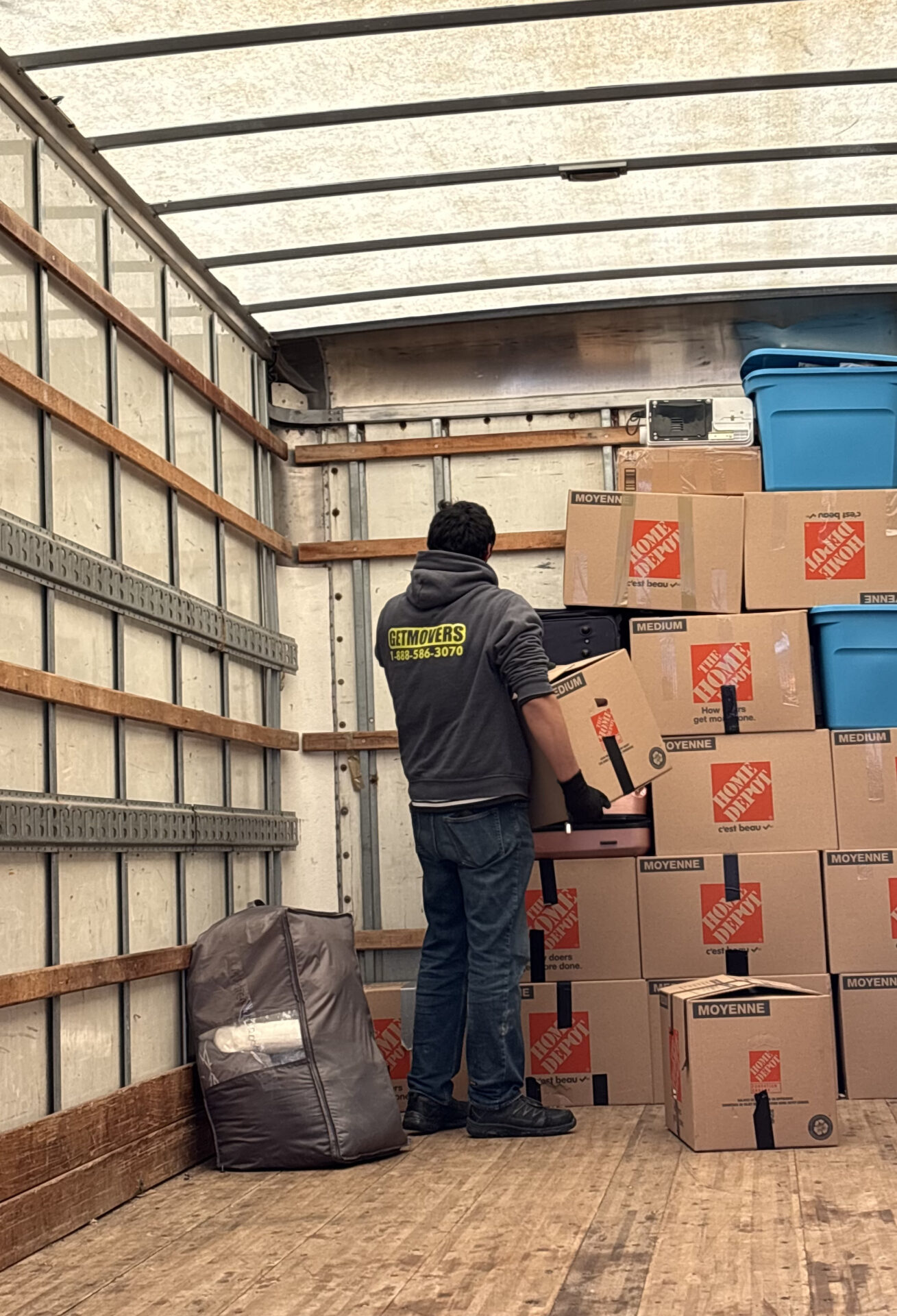 Professional movers maintaining clear pathways during the loading process in a Bonnie Doon home.