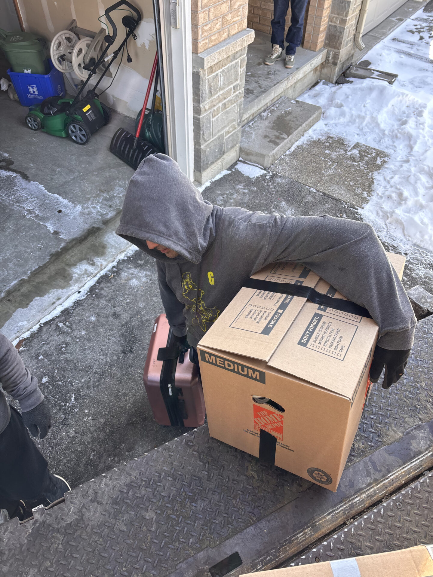 Professional movers maintaining clear pathways during the loading process in a Westmount home.