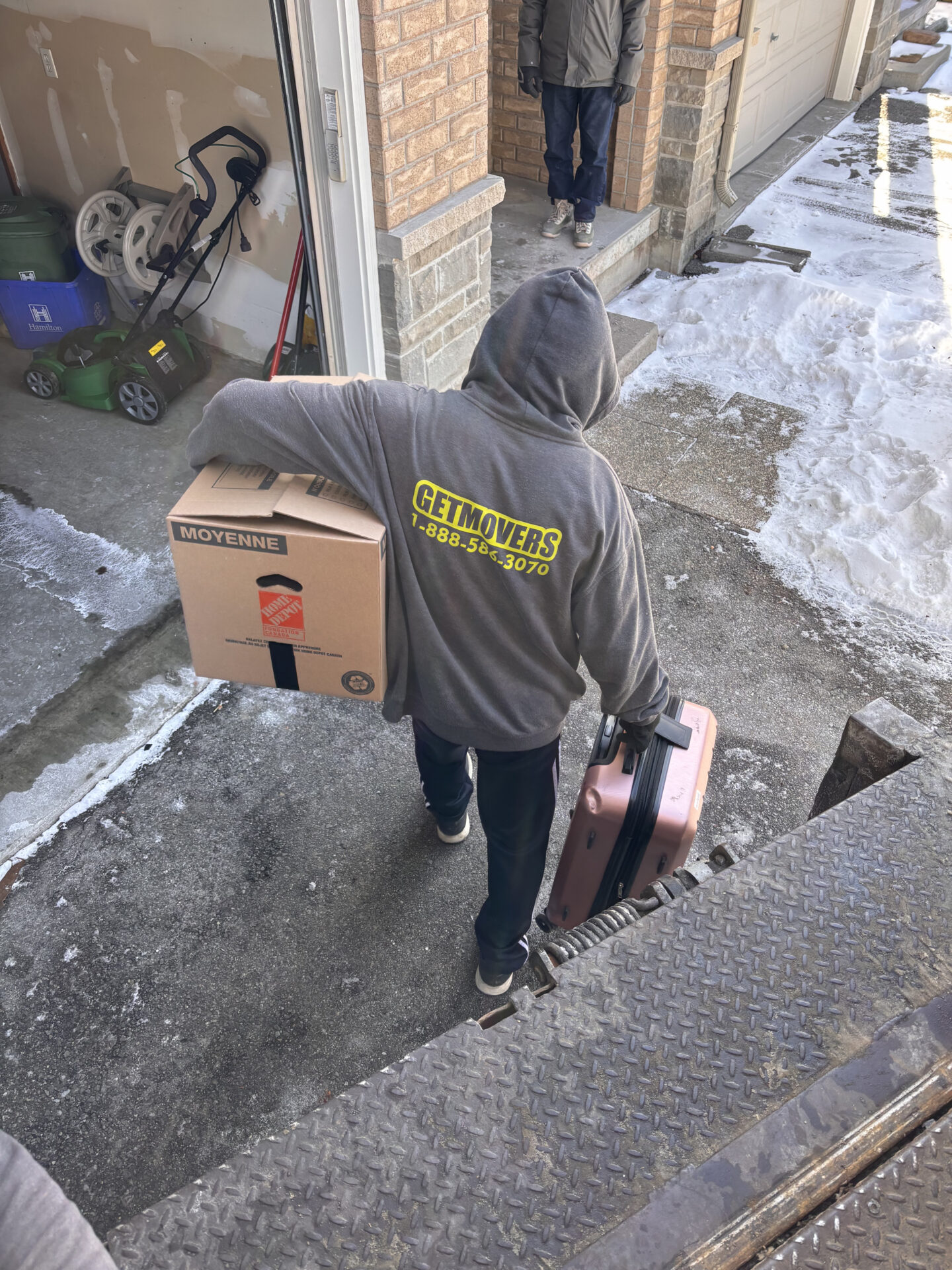Wrapped console being moved through hallway in Kitsilano.