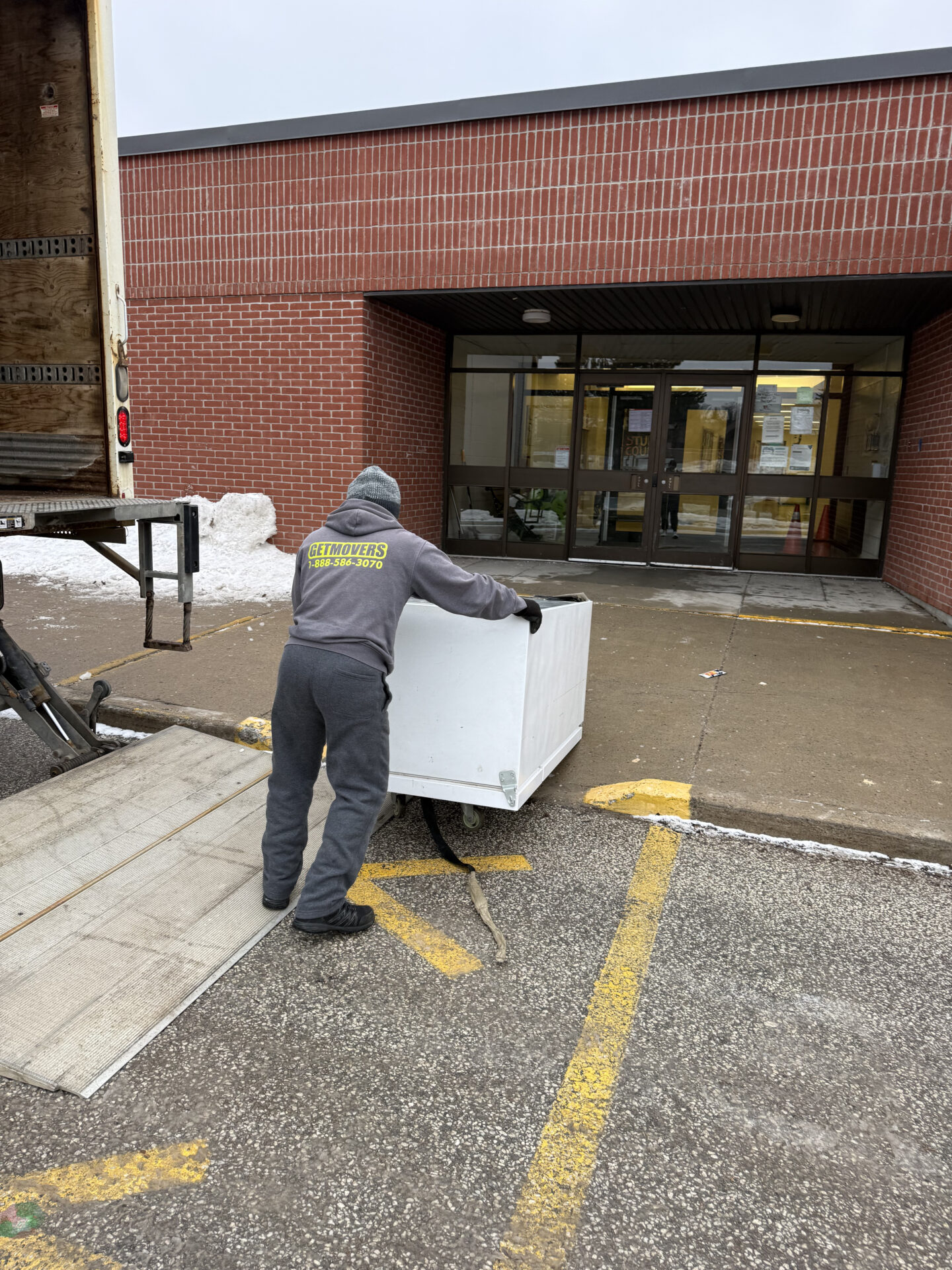 Professional movers maintaining clear pathways during the loading process in a Vandorf home.