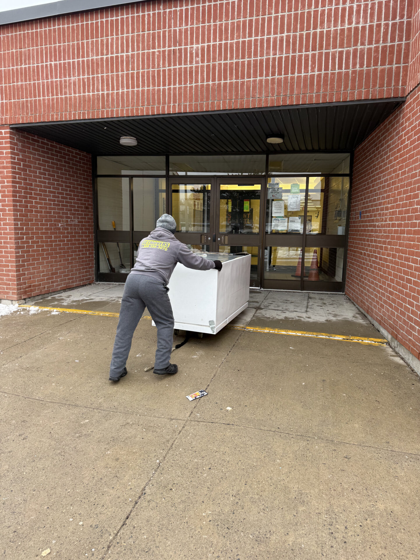 Professional movers maintaining clear pathways during the loading process in a Cherry Drive home.