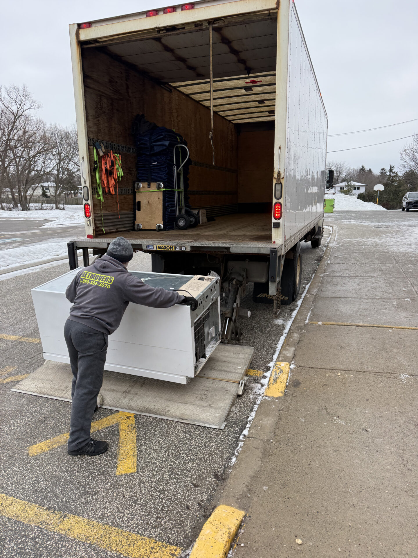 Professional movers maintaining clear pathways during the loading process in a Port Credit home.