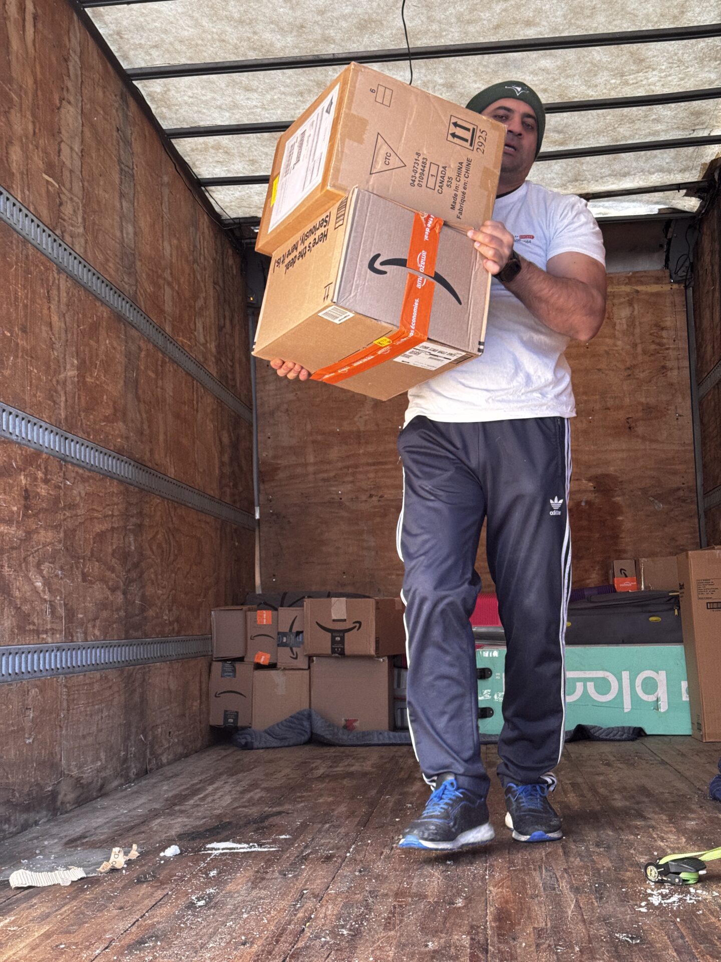 Professional movers loading fragile items in a balanced sequence.