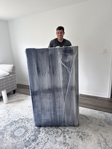 Movers carefully preparing furniture for a home move from Ringwood to Ballantrae South in Stouffville, ensuring safe winter transit.