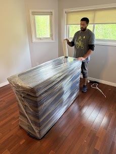 Movers carefully preparing furniture for a home move from Alcona to Belle Ewart in Innisfil, ensuring safe winter transit.