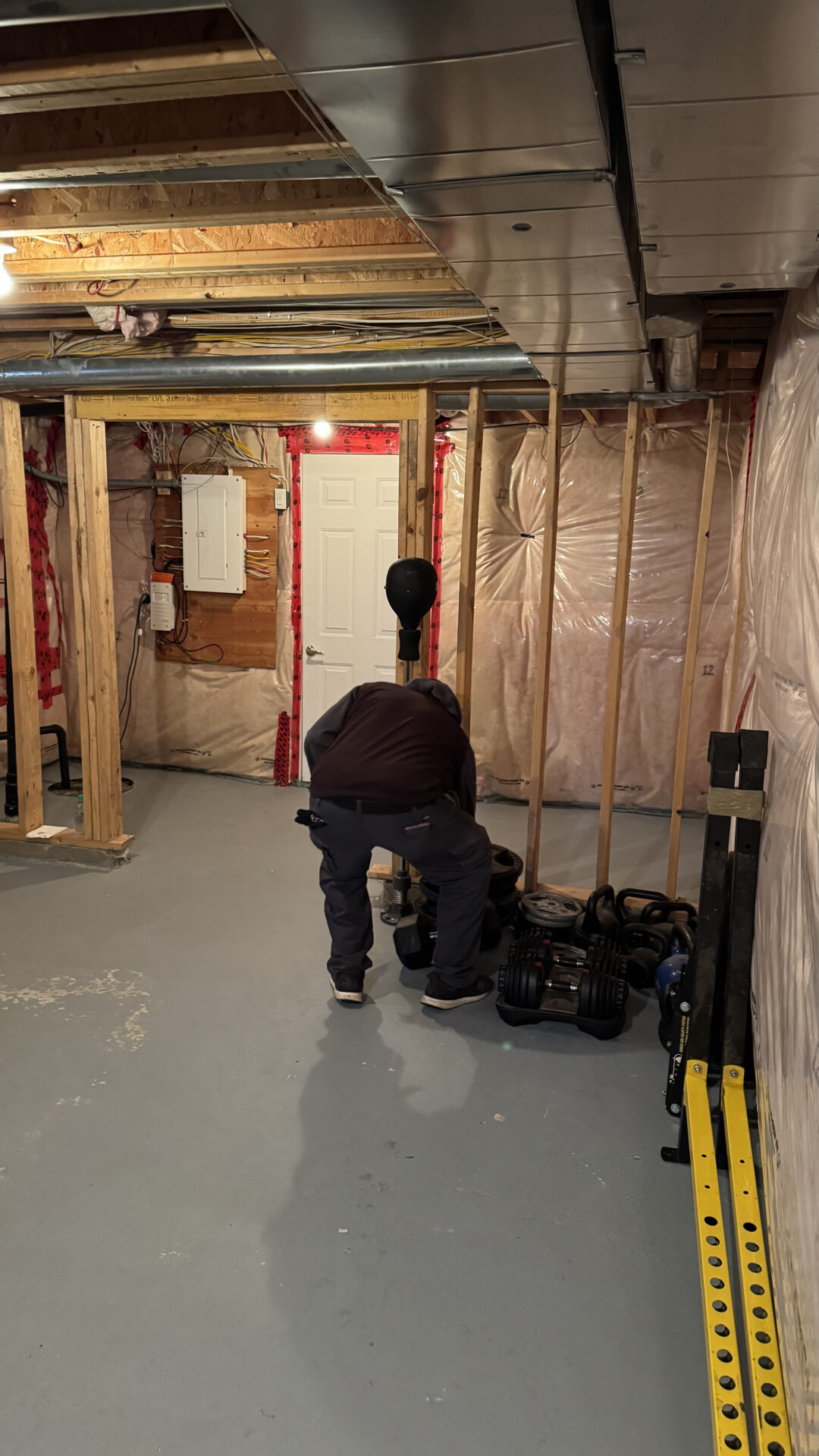 Movers positioning protected furniture on floor runners to prevent damage during the winter move.