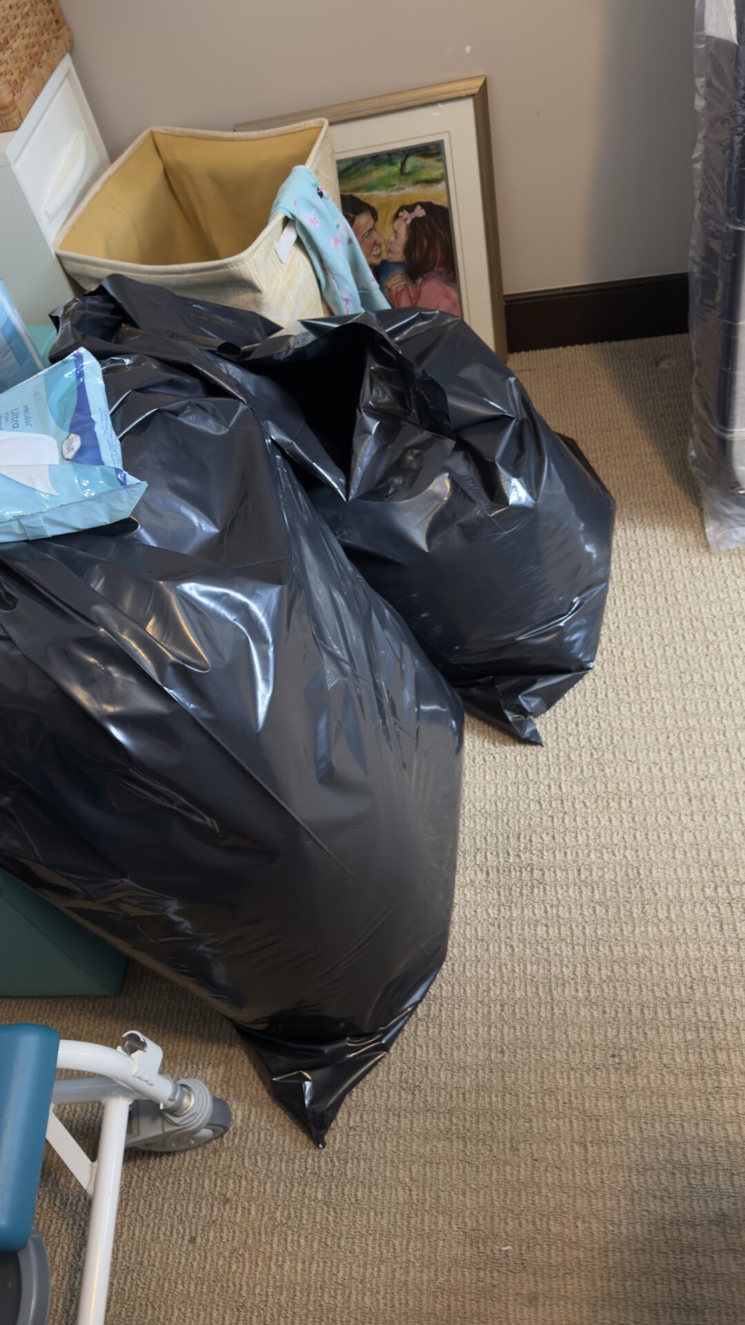 Furniture wrapped in protective blankets inside a London home.