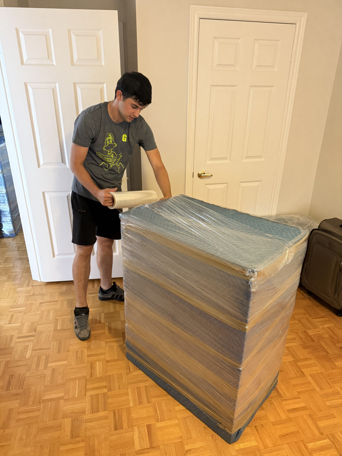 Professional movers maintaining clear pathways during the loading process in a Brightwood home.