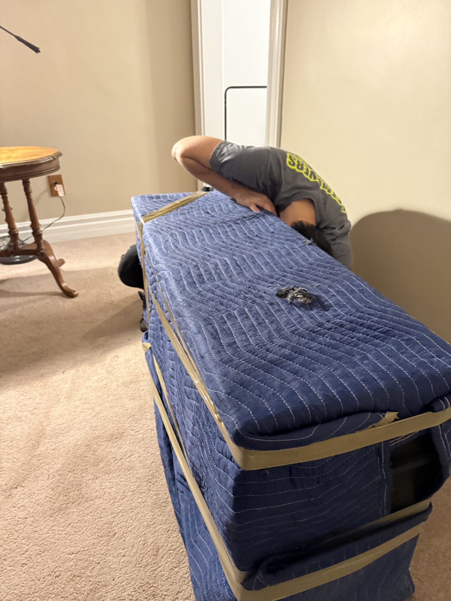 Professional movers maintaining clear pathways during the loading process in a Curran Hall home.