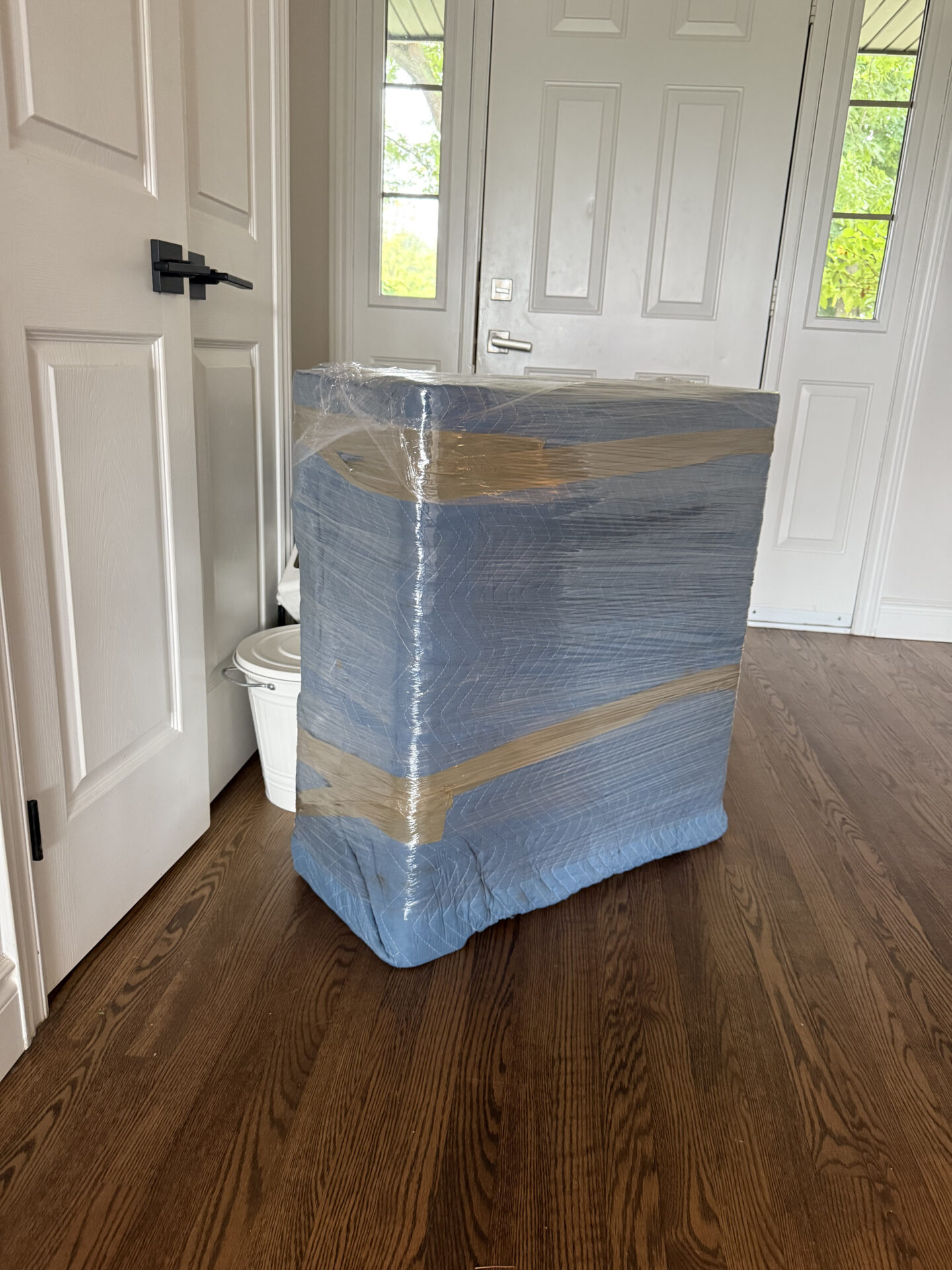 Fragile dessert plates being packed in cushioned sleeves during a Scarborough move.