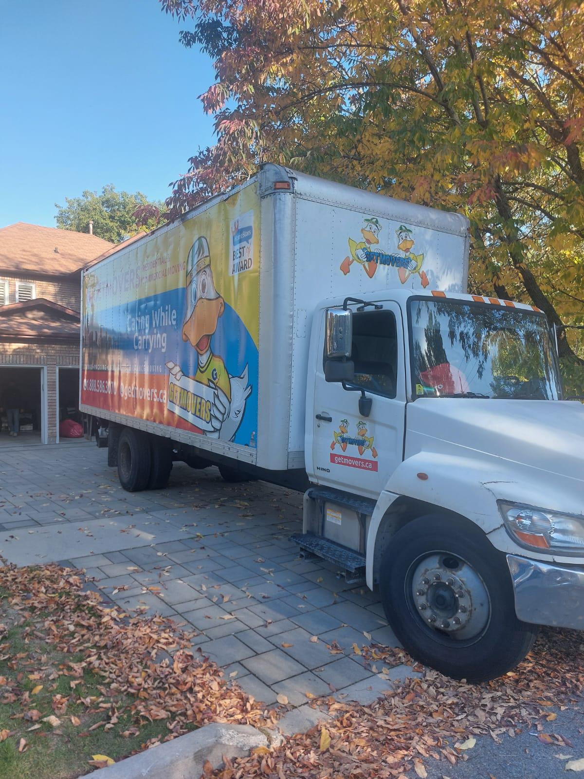 Professional movers maintaining clear pathways during the loading process in a Chelsea Green home.