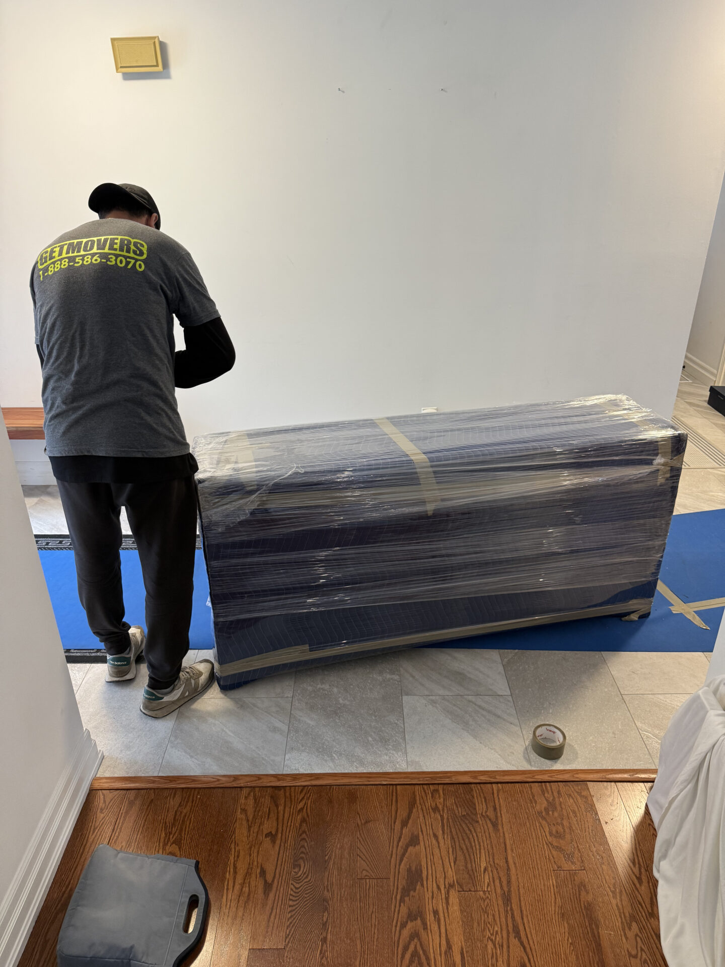 Movers carefully preparing furniture for a home move from Taunton to Northwood in Oshawa, ensuring safe winter transit.