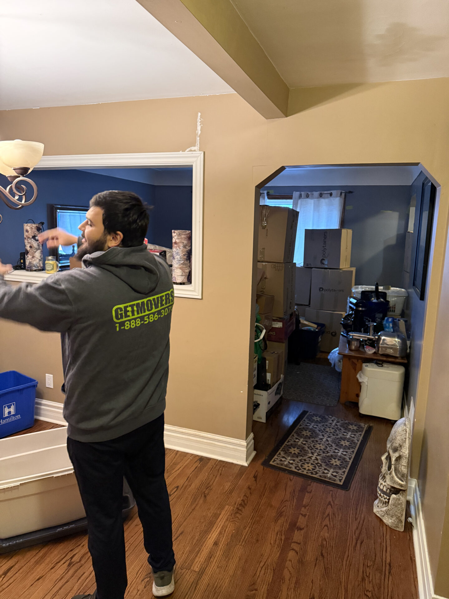 Professional movers maintaining clear pathways during the loading process in an Argyle home.