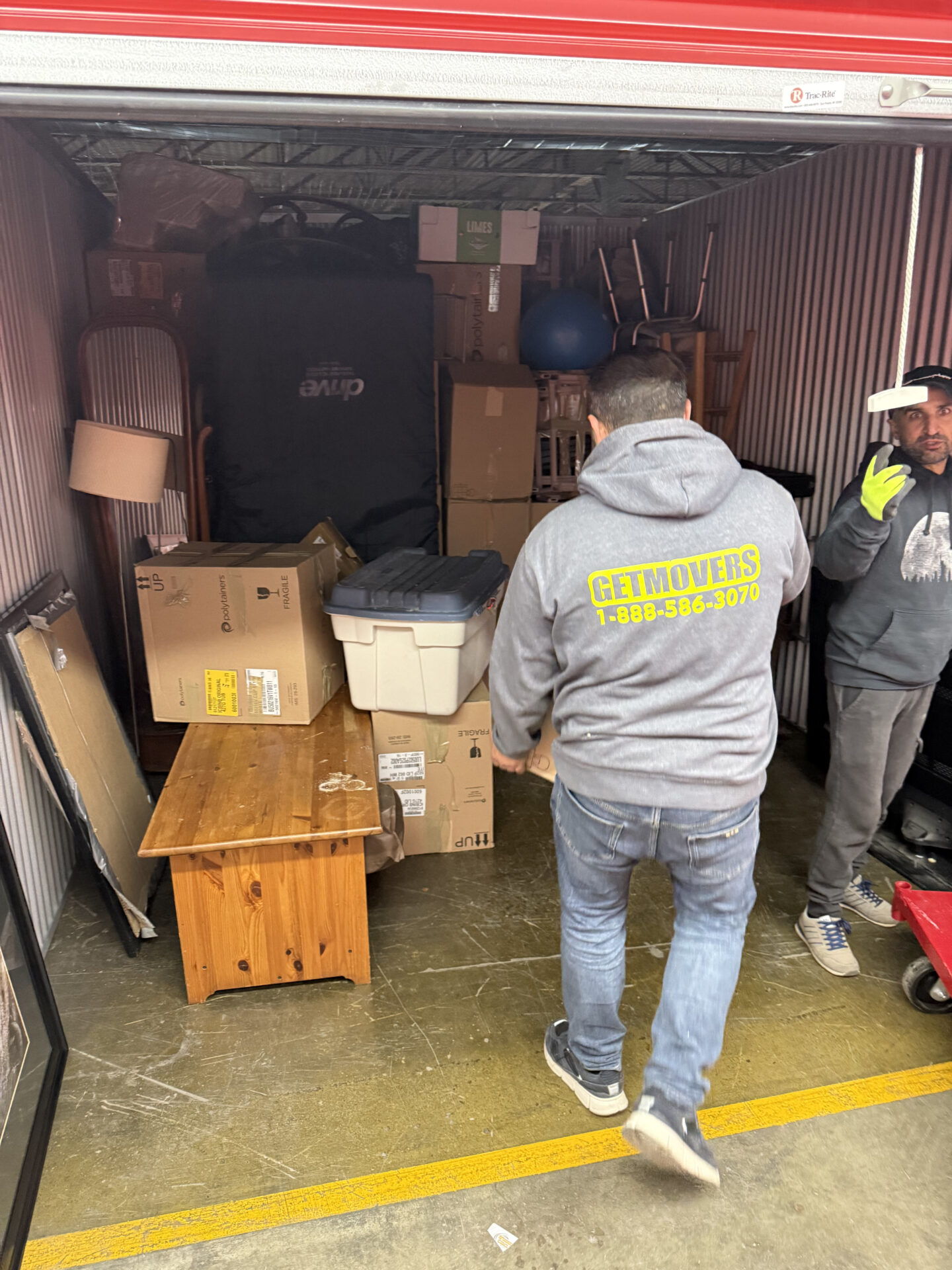 Professional movers maintaining clear pathways during the loading process in a Byron home.