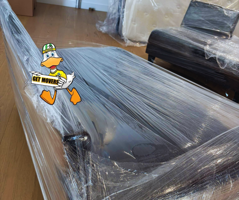 Professional movers maintaining clear pathways during the loading process in a Uplands home.