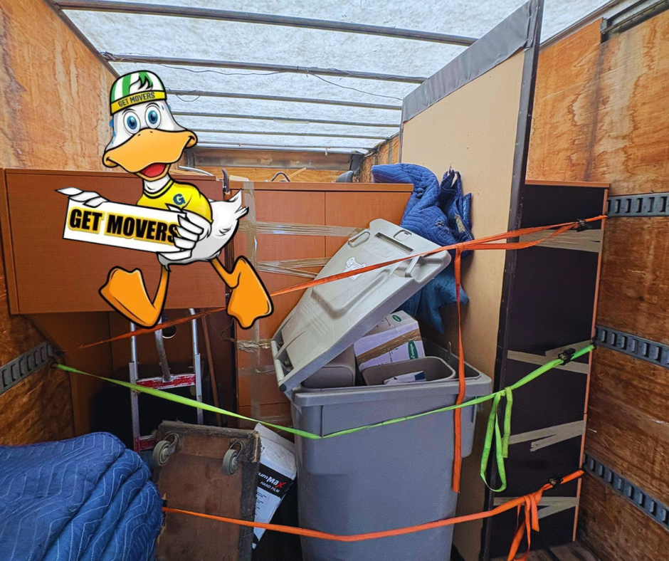 Professional movers maintaining clear pathways during the loading process in a Uplands home.