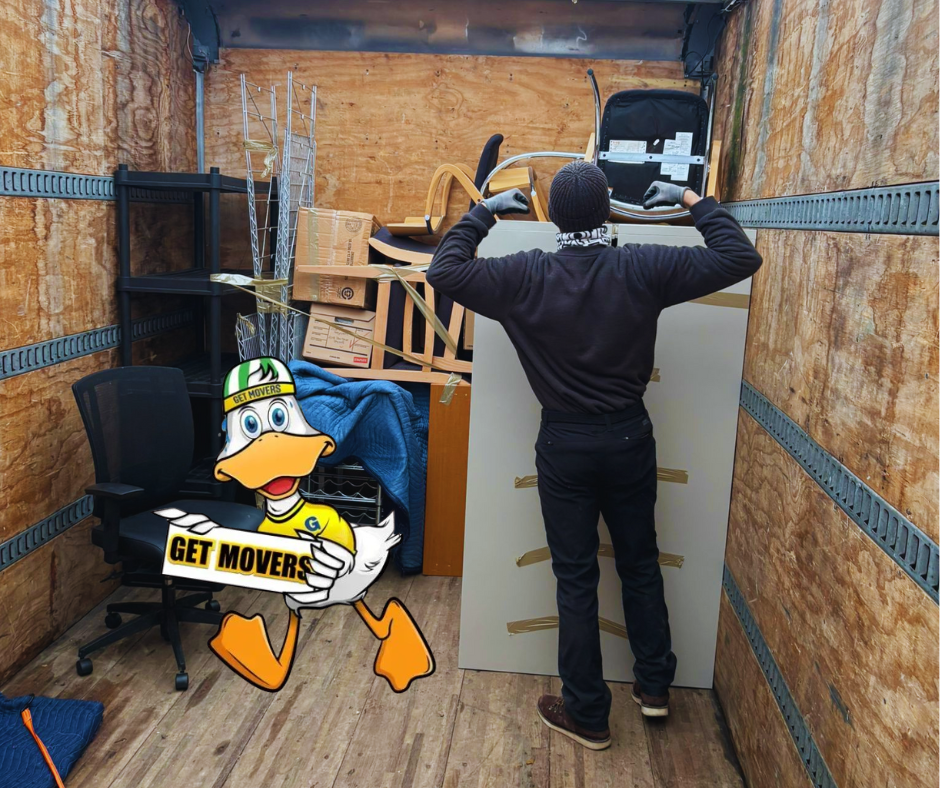 Professional movers maintaining clear pathways during the loading process in a Bathurst Manor home.