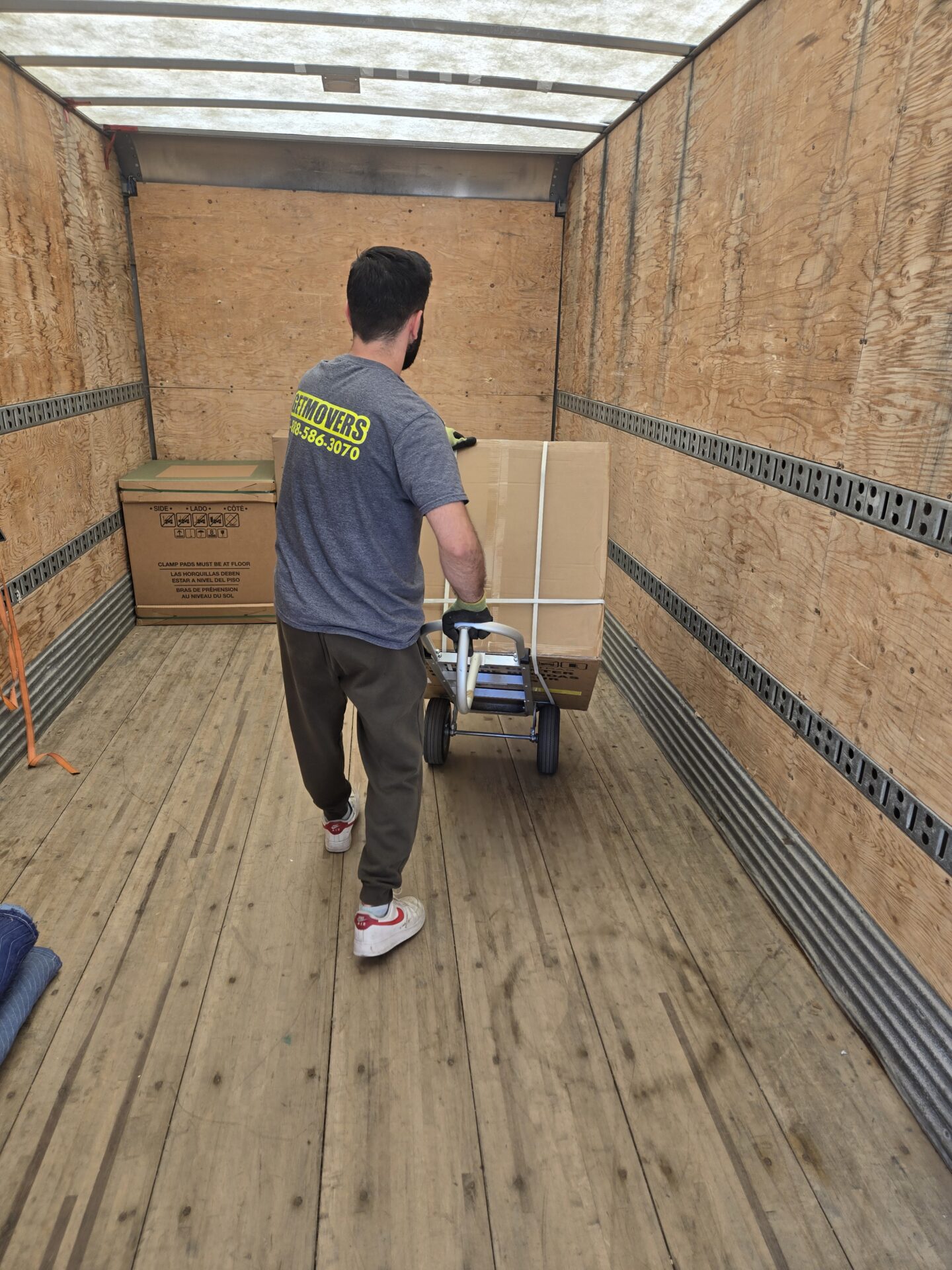 Movers wrapping furniture in Lantz home