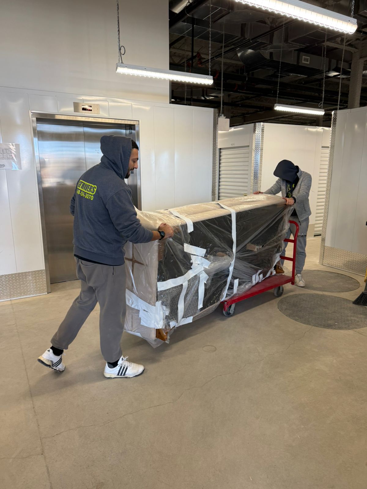 Movers wrapping furniture during a Caldwell Rd residential move