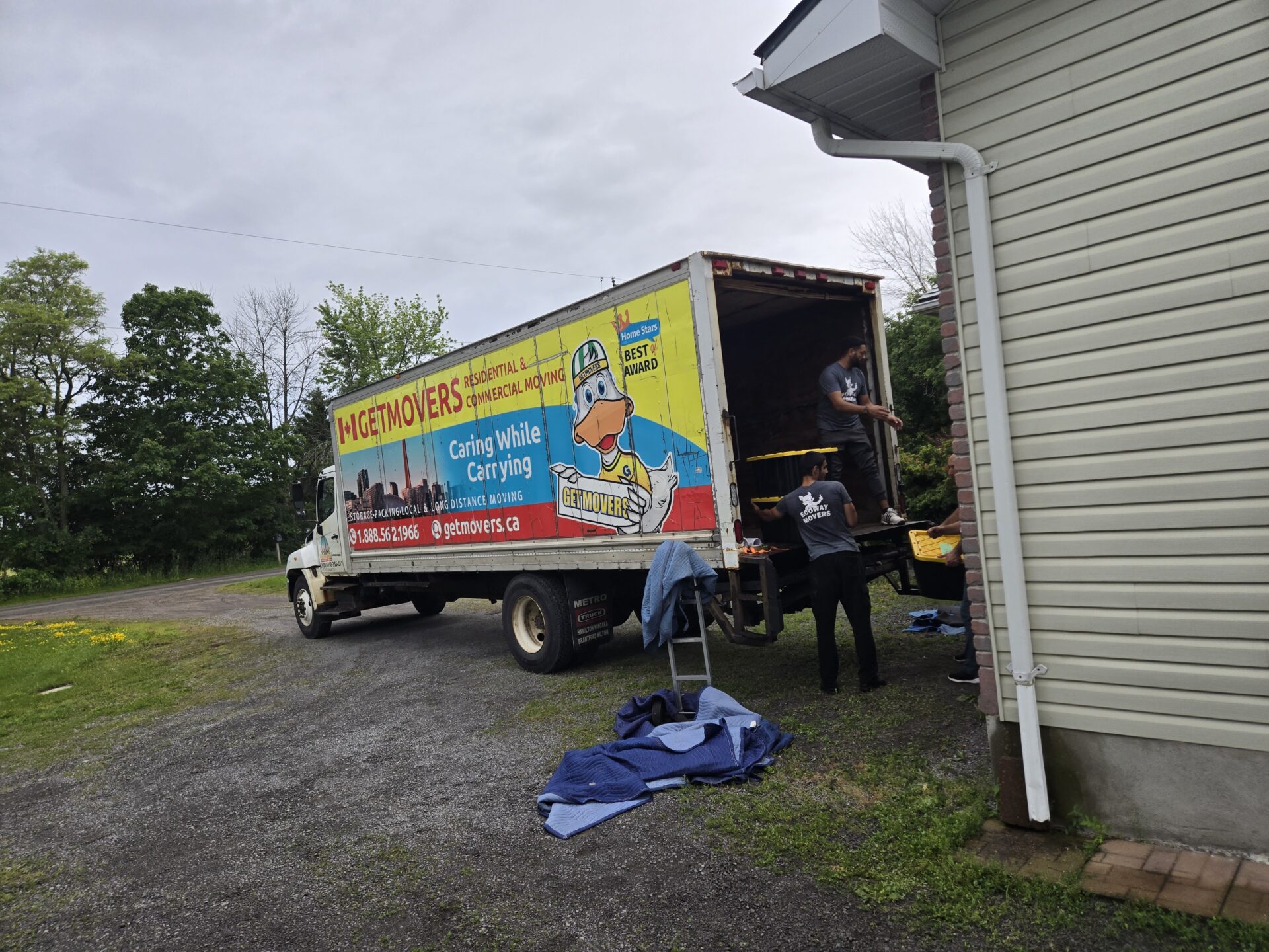Movers wrapping oversized estate furniture